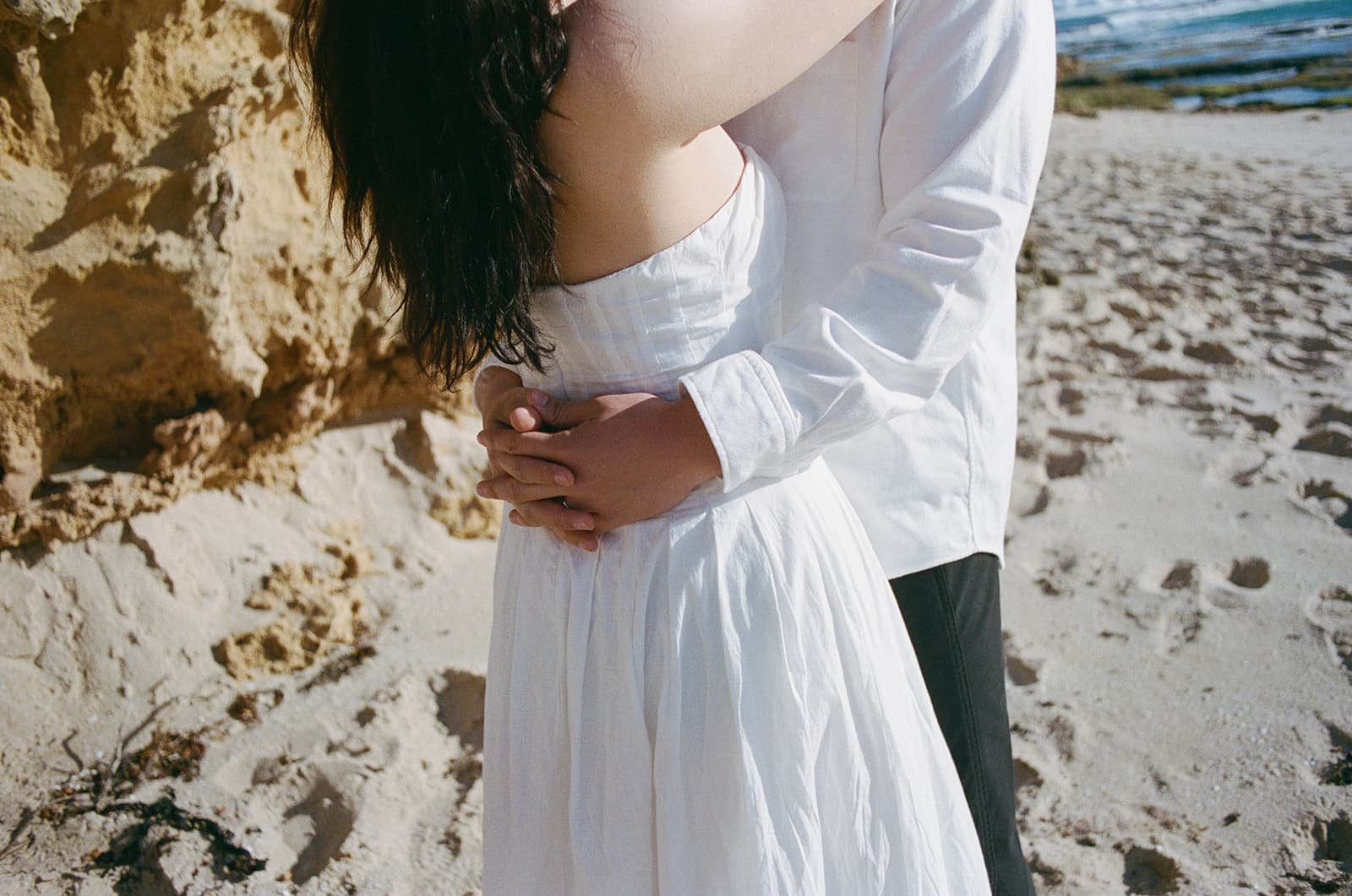 Kobe and Chesqa embracing on the beach